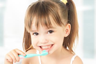 children's dentist medina | smiling girl brushing her teeth