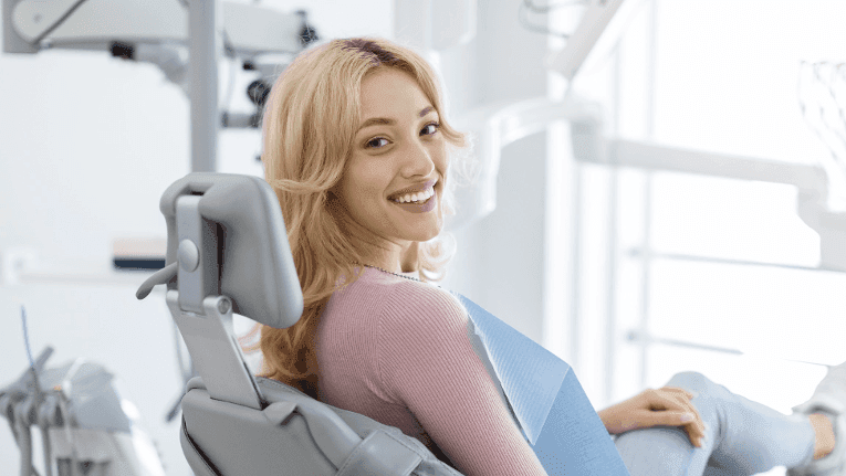 tooth replacement medina | woman smiling at dentist