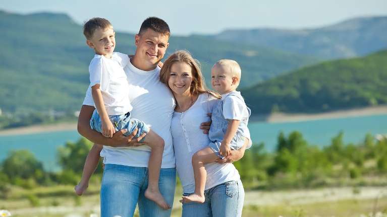 A family smiling at the lake | Medina dentist