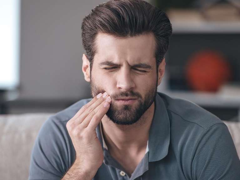 A man with wisdom tooth pain | tooth extractions Medina OH