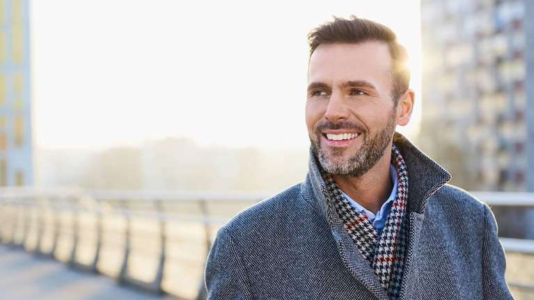 A man smiling outdoors | dentist in Medina OH