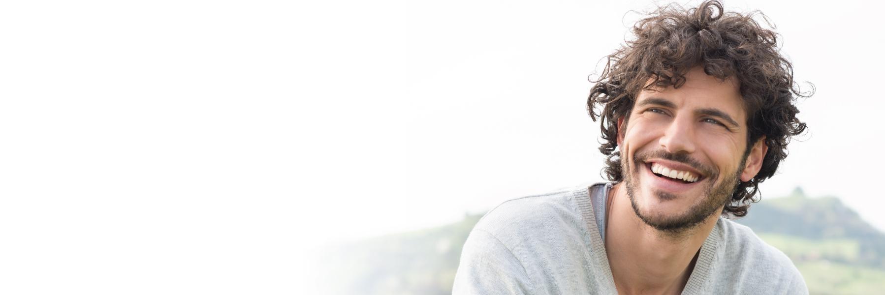 Patient smiling with fixed dental bridge in Medina, OH
